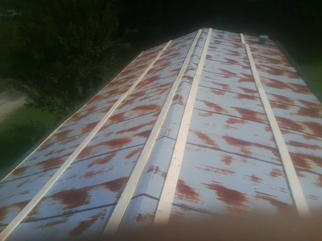 Rusted metal roof panels with new wood purlins before replacement — Storm Damage Roof Repair in Beechmont by Roofing Brothers