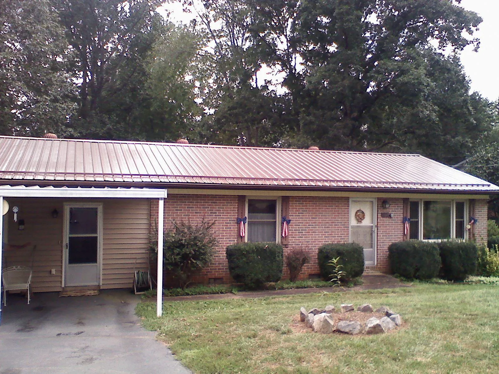 Bronze metal roof and carport on a brick ranch home — Roof Repair work by our crew in Beechmont